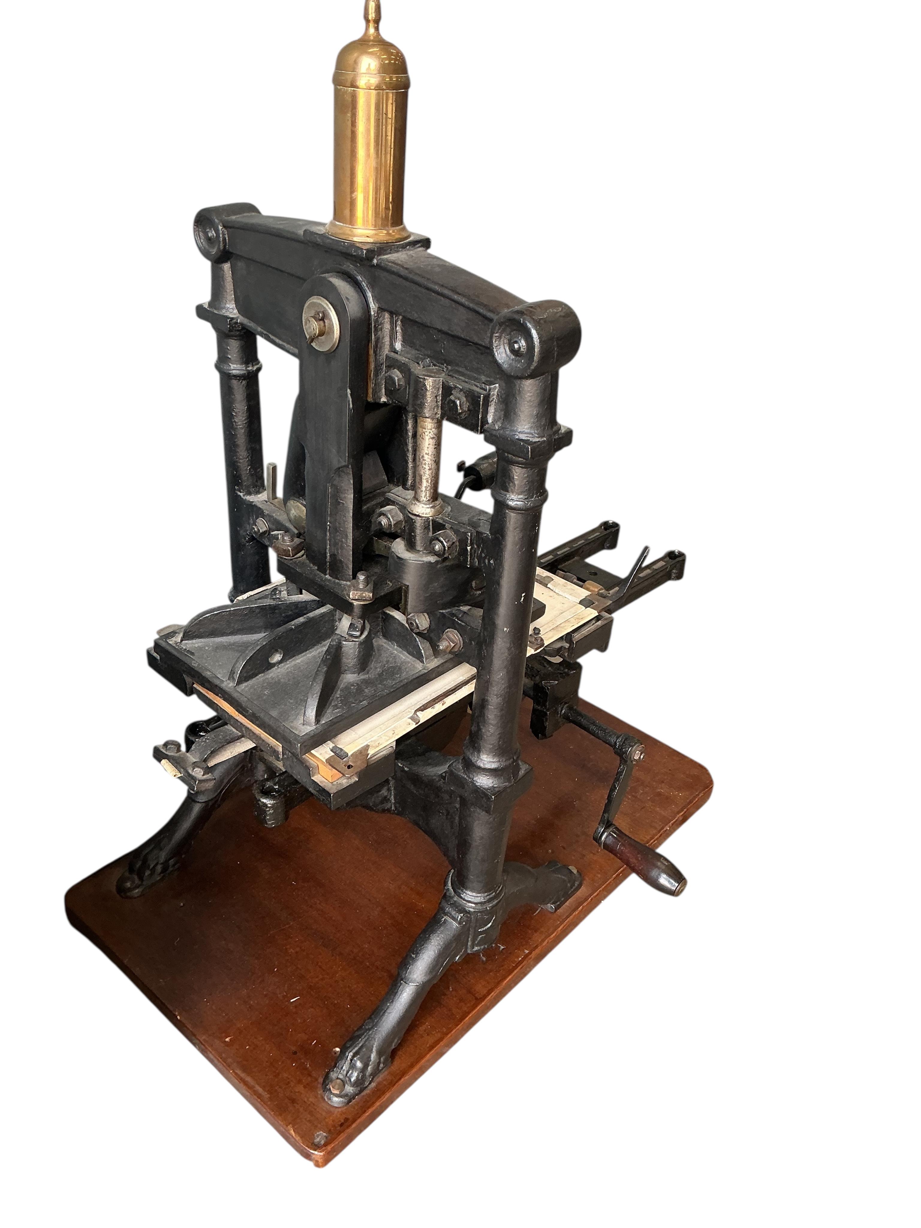 A Victorian cast iron Albion printing press by Wood and Sherwood, Aldersgate Street, London, width 87cm, height 105cm, together with a stained pine chest of print making accessories. Provenance: This was the property of